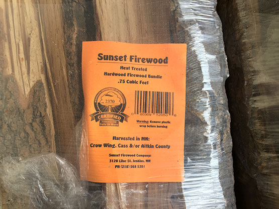 Although infestations are present in both states, most of Minnesota and Wisconsin have not yet become infested by emerald ash borer (EAB; Agrilus planipennis); the movement of firewood is a primary vector for the spread of EAB and other pests and only certified firewood, as shown in these pictures, should be offered for sale (Photo Credit: Jim Calkins).